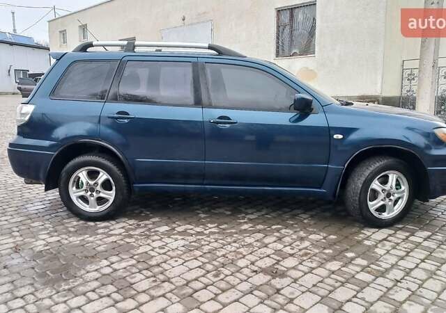 Синий Мицубиси Аутлендер, объемом двигателя 2 л и пробегом 400 тыс. км за 4400 $, фото 12 на Automoto.ua