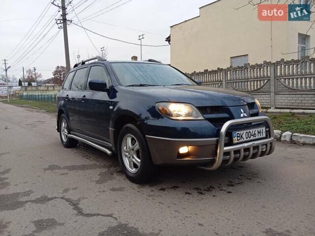 Синий Мицубиси Аутлендер, объемом двигателя 2.38 л и пробегом 175 тыс. км за 6500 $, фото 1 на Automoto.ua