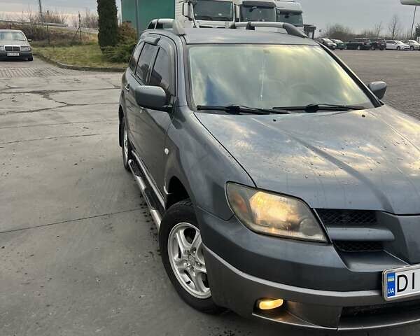 Синий Мицубиси Аутлендер, объемом двигателя 2.38 л и пробегом 300 тыс. км за 4200 $, фото 1 на Automoto.ua