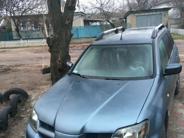 Синий Мицубиси Аутлендер, объемом двигателя 2.4 л и пробегом 218 тыс. км за 3500 $, фото 2 на Automoto.ua