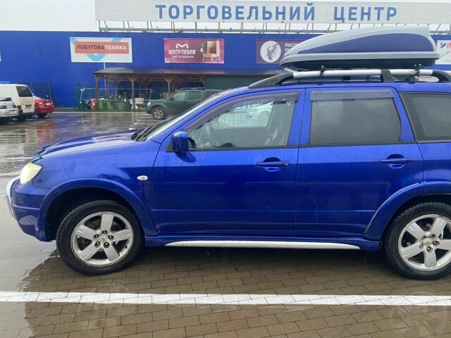Синий Мицубиси Аутлендер, объемом двигателя 2 л и пробегом 234 тыс. км за 5500 $, фото 1 на Automoto.ua