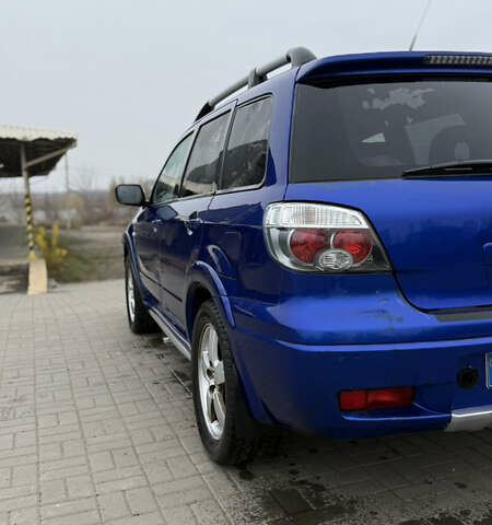 Синий Мицубиси Аутлендер, объемом двигателя 2.4 л и пробегом 243 тыс. км за 5000 $, фото 12 на Automoto.ua