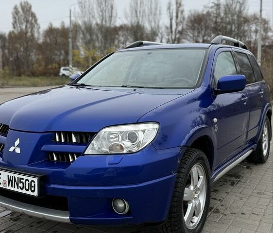 Синий Мицубиси Аутлендер, объемом двигателя 2.4 л и пробегом 243 тыс. км за 5000 $, фото 1 на Automoto.ua