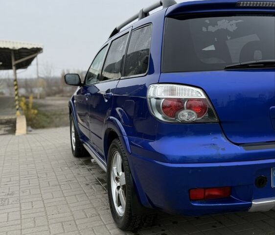 Синий Мицубиси Аутлендер, объемом двигателя 2.4 л и пробегом 243 тыс. км за 5000 $, фото 12 на Automoto.ua
