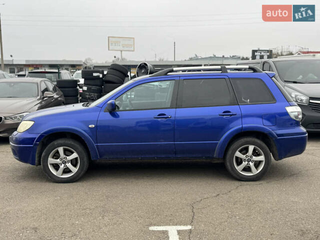 Синий Мицубиси Аутлендер, объемом двигателя 2.4 л и пробегом 245 тыс. км за 4600 $, фото 2 на Automoto.ua