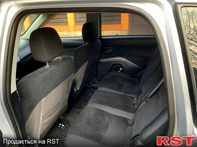 Синий Мицубиси Аутлендер, объемом двигателя 24 л и пробегом 205 тыс. км за 8300 $, фото 1 на Automoto.ua