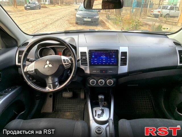 Синий Мицубиси Аутлендер, объемом двигателя 24 л и пробегом 205 тыс. км за 8300 $, фото 3 на Automoto.ua