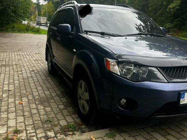 Синий Мицубиси Аутлендер, объемом двигателя 2.4 л и пробегом 284 тыс. км за 9250 $, фото 1 на Automoto.ua