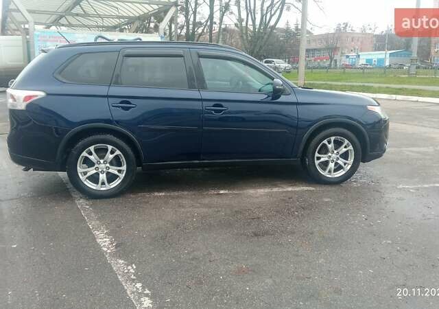 Синий Мицубиси Аутлендер, объемом двигателя 2.4 л и пробегом 230 тыс. км за 11300 $, фото 1 на Automoto.ua