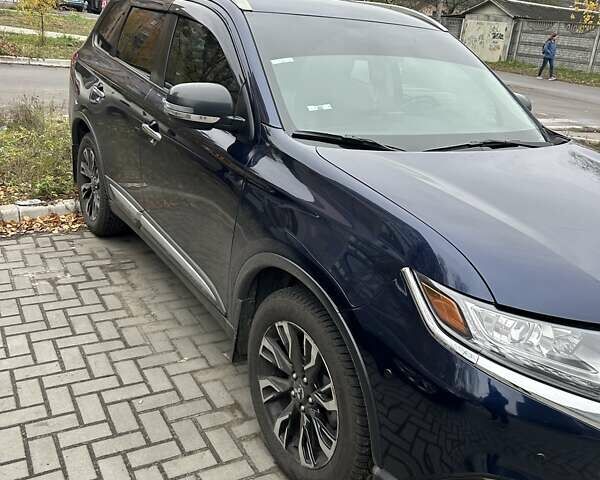 Синий Мицубиси Аутлендер, объемом двигателя 2.36 л и пробегом 129 тыс. км за 16500 $, фото 1 на Automoto.ua