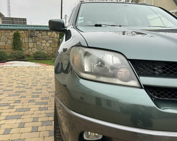 Зеленый Мицубиси Аутлендер, объемом двигателя 2.38 л и пробегом 250 тыс. км за 7200 $, фото 23 на Automoto.ua