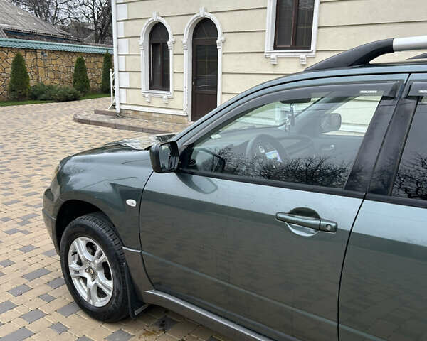 Зеленый Мицубиси Аутлендер, объемом двигателя 2.38 л и пробегом 250 тыс. км за 7200 $, фото 45 на Automoto.ua