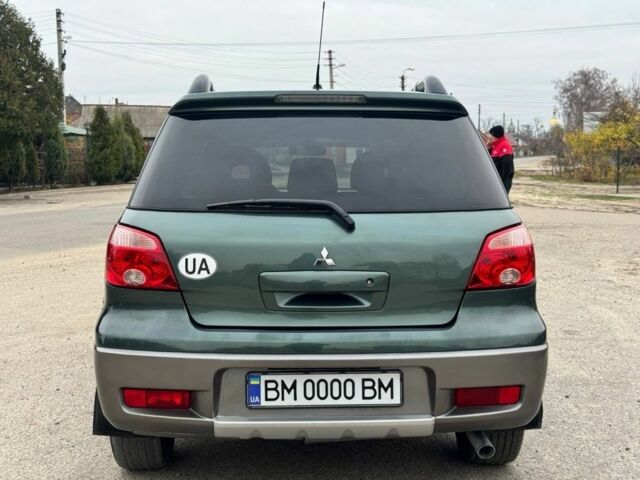 Зелений Міцубісі Аутлендер, об'ємом двигуна 2 л та пробігом 194 тис. км за 6350 $, фото 5 на Automoto.ua