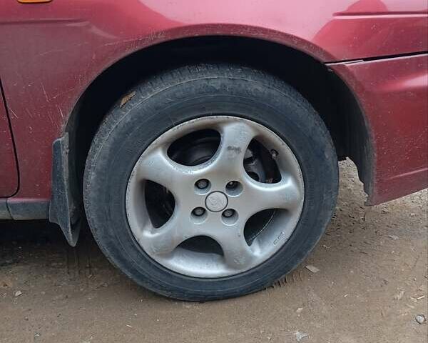 Красный Ниссан Альмера, объемом двигателя 1.4 л и пробегом 300 тыс. км за 1100 $, фото 1 на Automoto.ua