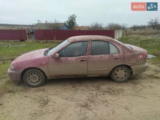 Красный Ниссан Альмера, объемом двигателя 2 л и пробегом 200 тыс. км за 1300 $, фото 1 на Automoto.ua