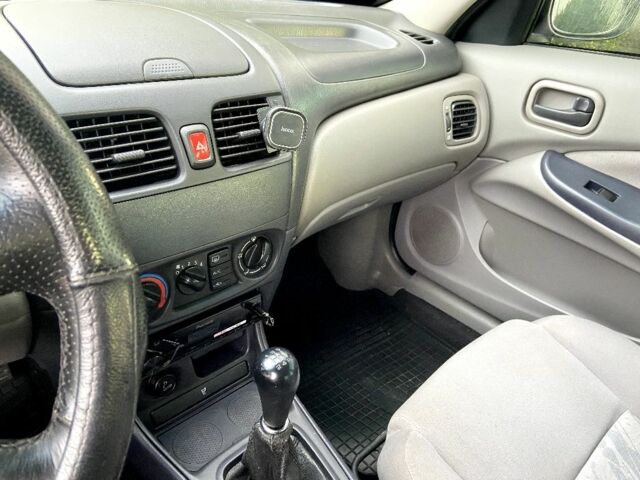 Синій Ніссан Альмера, об'ємом двигуна 1 л та пробігом 124 тис. км за 4250 $, фото 13 на Automoto.ua