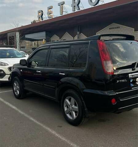 Черный Ниссан ИксТрейл, объемом двигателя 2.5 л и пробегом 261 тыс. км за 8300 $, фото 3 на Automoto.ua