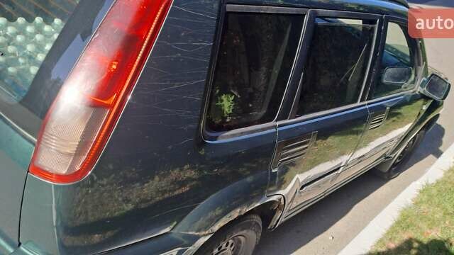 Зеленый Ниссан ИксТрейл, объемом двигателя 2.5 л и пробегом 309 тыс. км за 4842 $, фото 2 на Automoto.ua