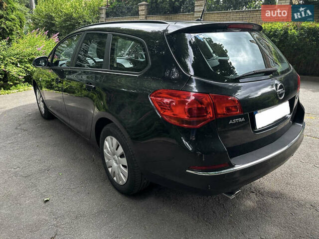 Черный Опель Астра, объемом двигателя 1.4 л и пробегом 180 тыс. км за 5900 $, фото 6 на Automoto.ua