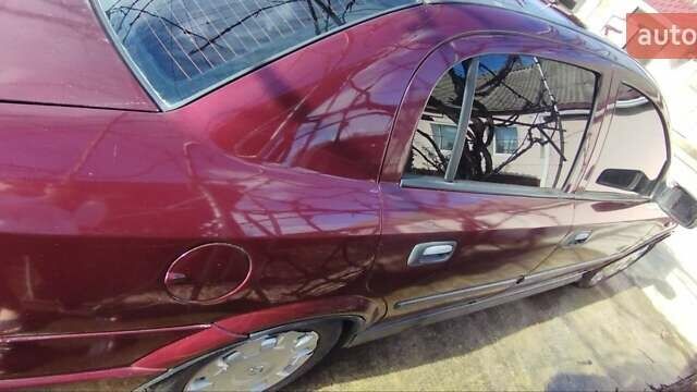 Красный Опель Астра, объемом двигателя 1.4 л и пробегом 297 тыс. км за 2500 $, фото 8 на Automoto.ua