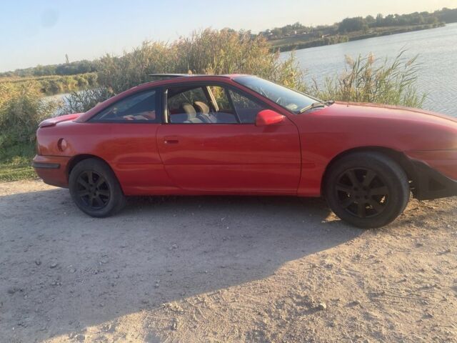 Красный Опель Калибра, объемом двигателя 2 л и пробегом 270 тыс. км за 1700 $, фото 2 на Automoto.ua