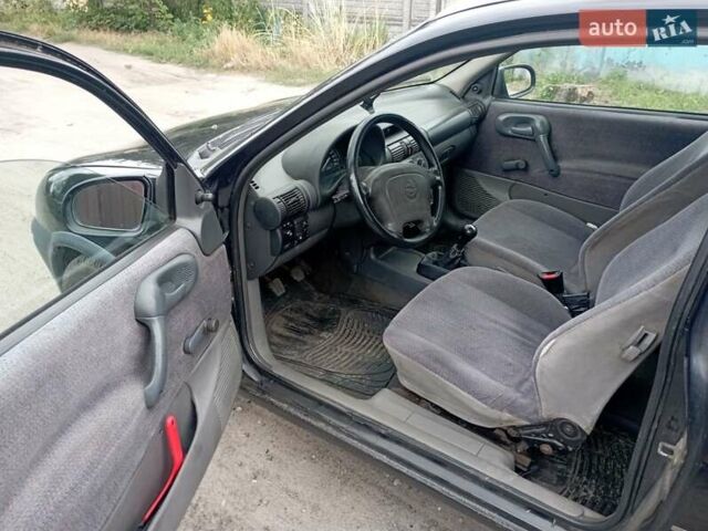 Черный Опель Корса, объемом двигателя 1.2 л и пробегом 450 тыс. км за 1700 $, фото 4 на Automoto.ua