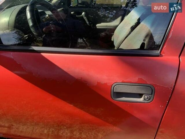 Красный Опель Корса, объемом двигателя 1.2 л и пробегом 285 тыс. км за 1500 $, фото 6 на Automoto.ua