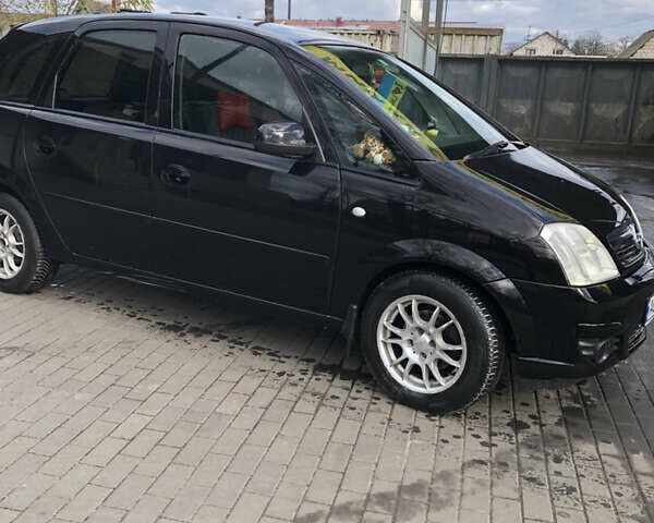 Черный Опель Мерива, объемом двигателя 1.25 л и пробегом 197 тыс. км за 3650 $, фото 2 на Automoto.ua