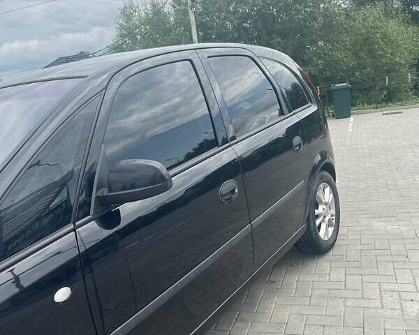 Черный Опель Мерива, объемом двигателя 1.8 л и пробегом 176 тыс. км за 4600 $, фото 3 на Automoto.ua