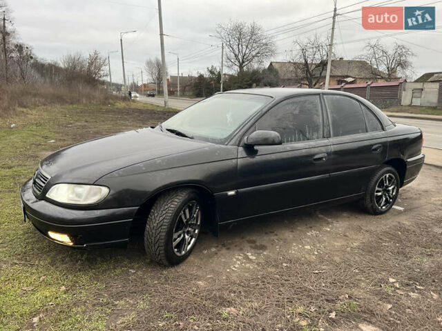 Черный Опель Омега, объемом двигателя 2.2 л и пробегом 319 тыс. км за 2000 $, фото 1 на Automoto.ua