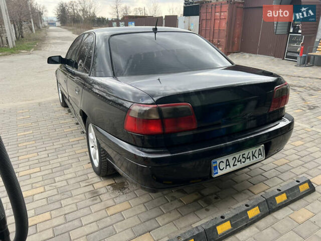 Черный Опель Омега, объемом двигателя 2.5 л и пробегом 280 тыс. км за 4300 $, фото 4 на Automoto.ua