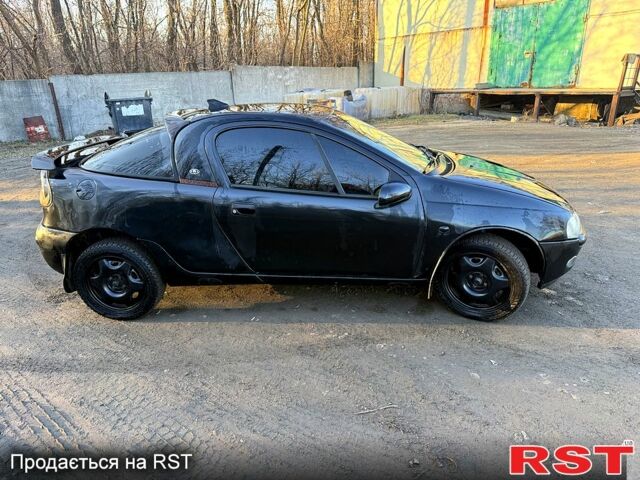 Черный Опель Тигра, объемом двигателя 1.4 л и пробегом 444 тыс. км за 1375 $, фото 3 на Automoto.ua