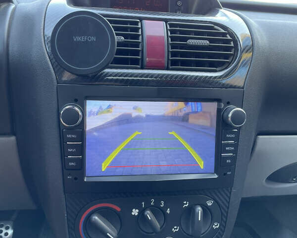 Черный Опель Тигра, объемом двигателя 1.25 л и пробегом 185 тыс. км за 4000 $, фото 11 на Automoto.ua