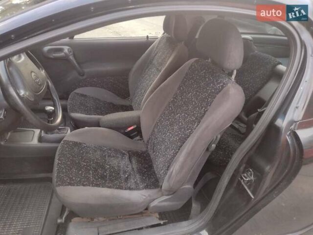 Чорний Опель Тігра, об'ємом двигуна 1.4 л та пробігом 260 тис. км за 2000 $, фото 15 на Automoto.ua