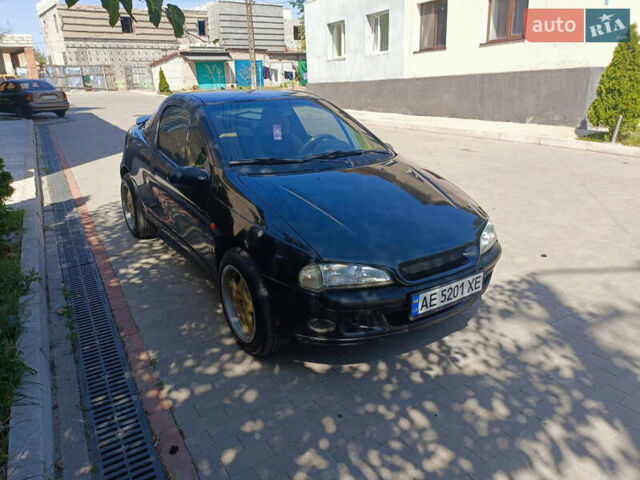 Черный Опель Тигра, объемом двигателя 1.4 л и пробегом 229 тыс. км за 3300 $, фото 3 на Automoto.ua