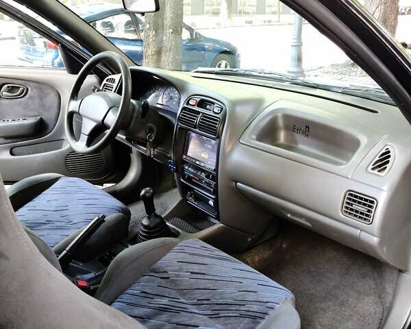 Черный Сузуки Балеро, объемом двигателя 1.3 л и пробегом 332 тыс. км за 2800 $, фото 2 на Automoto.ua