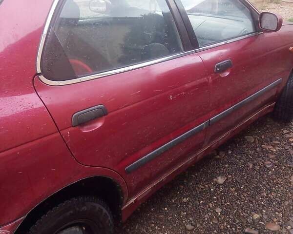 Красный Сузуки Балеро, объемом двигателя 1.3 л и пробегом 174 тыс. км за 1550 $, фото 2 на Automoto.ua