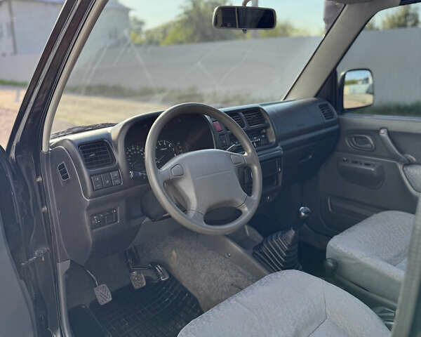 Черный Сузуки Джимни, объемом двигателя 1.3 л и пробегом 100 тыс. км за 7200 $, фото 12 на Automoto.ua