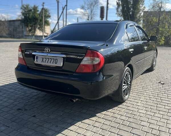 Черный Тойота Камри, объемом двигателя 2.4 л и пробегом 350 тыс. км за 6800 $, фото 5 на Automoto.ua