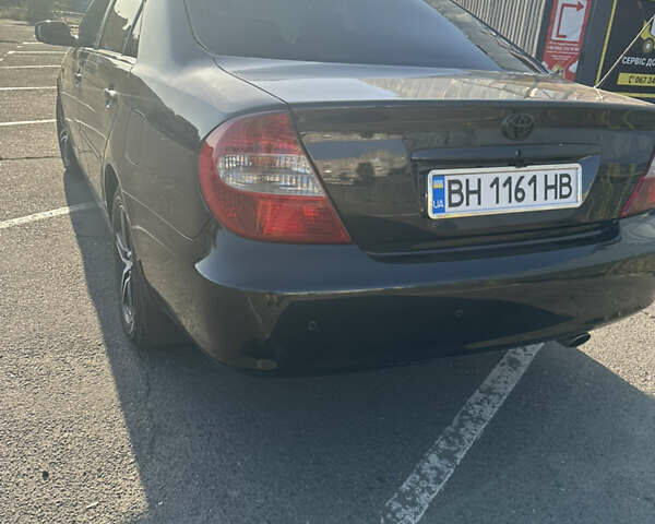 Черный Тойота Камри, объемом двигателя 2.4 л и пробегом 312 тыс. км за 7200 $, фото 9 на Automoto.ua