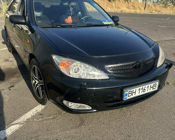Черный Тойота Камри, объемом двигателя 2.4 л и пробегом 312 тыс. км за 7200 $, фото 1 на Automoto.ua