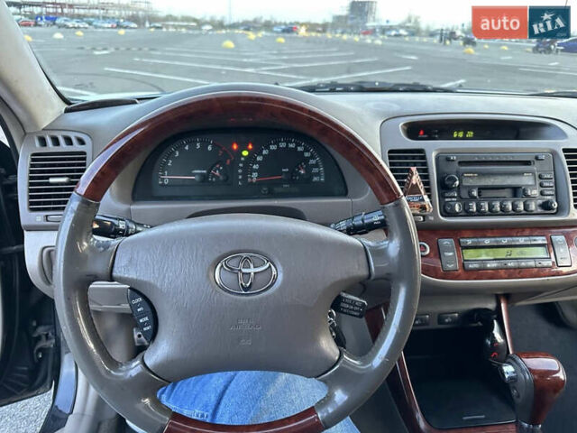 Черный Тойота Камри, объемом двигателя 2.4 л и пробегом 315 тыс. км за 5800 $, фото 13 на Automoto.ua