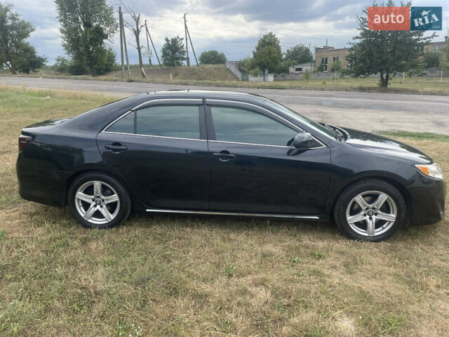 Черный Тойота Камри, объемом двигателя 2.5 л и пробегом 250 тыс. км за 10900 $, фото 1 на Automoto.ua
