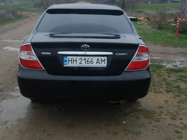 Черный Тойота Камри, объемом двигателя 2.4 л и пробегом 290 тыс. км за 7000 $, фото 1 на Automoto.ua