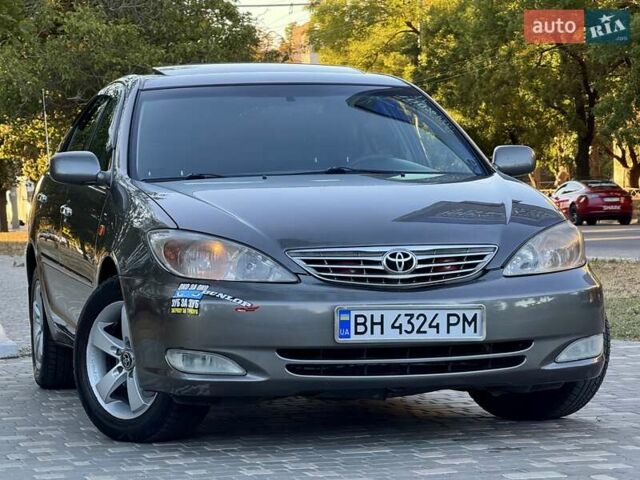 Серый Тойота Камри, объемом двигателя 2.4 л и пробегом 257 тыс. км за 5400 $, фото 67 на Automoto.ua