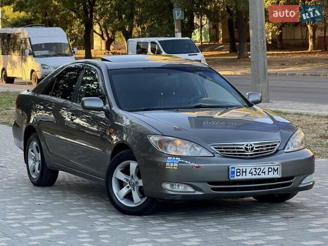 Серый Тойота Камри, объемом двигателя 2.4 л и пробегом 257 тыс. км за 5400 $, фото 64 на Automoto.ua