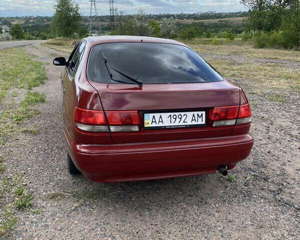 Червоний Тойота Каріна, об'ємом двигуна 1.6 л та пробігом 260 тис. км за 2100 $, фото 2 на Automoto.ua