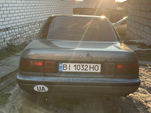 Серый Тойота Карина, объемом двигателя 1.6 л и пробегом 500 тыс. км за 600 $, фото 1 на Automoto.ua