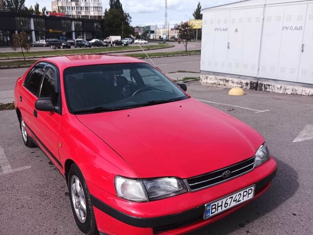 Червоний Тойота Carina E, об'ємом двигуна 2 л та пробігом 290 тис. км за 2300 $, фото 1 на Automoto.ua