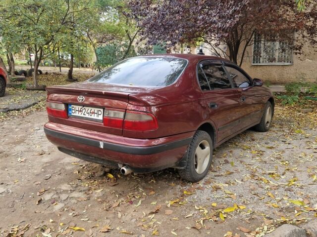Червоний Тойота Carina E, об'ємом двигуна 1.6 л та пробігом 220 тис. км за 1500 $, фото 6 на Automoto.ua
